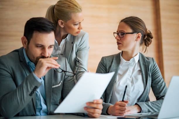 istock Close-up image of negative business people arguing over document, portrait. 1211579473
