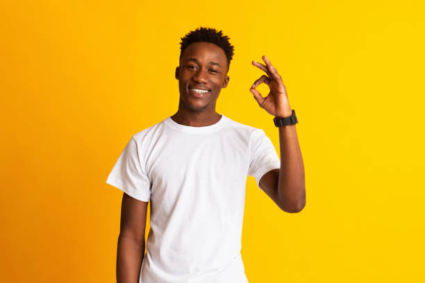istock African guy showing ok sign and widely smiling 1211579547