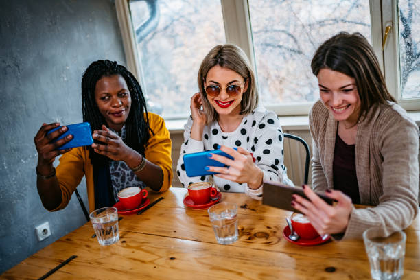 istock Girl friends making selfie at coffee time 1211581521
