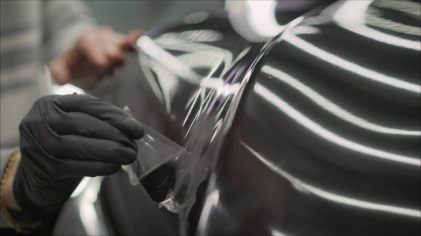 istock closeup peeling off protective film from a car 1211582241