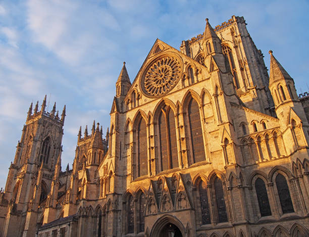 istock a side view of york minster in sunlight against a blue cloudy sky 1211582321