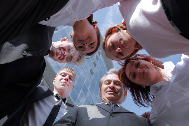 istock bottom view.successful business team standing in the circle 1211585015