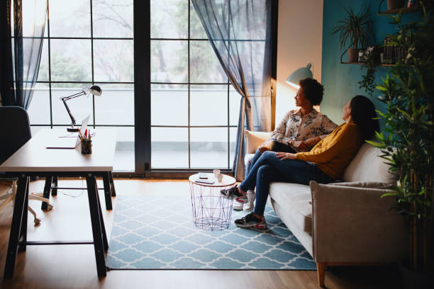 istock Two female friends spending time together at home drinking coffee and discussing 1211585238
