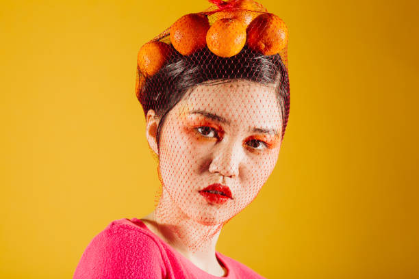 young asian woman with tangerines - vibrant color new traditional culture saturated color imagens e fotografias de stock