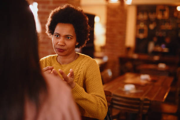 istock Serious friends having a conversation in a bar 1211586046