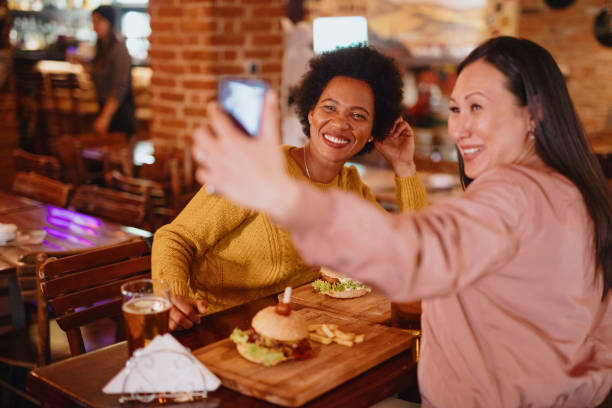 istock Happy female friends taking selfie 1211586299