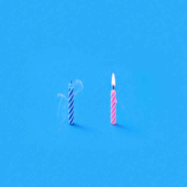 istock Two cake's candles one burning and another is blown out. 1211587908