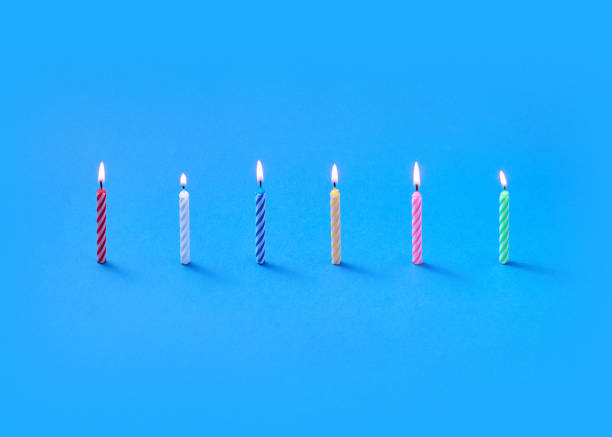 istock Light burning vertical candles for sweet dessert and cakes. 1211587920