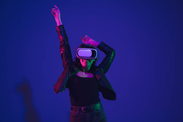 istock Caucasian woman's portrait isolated on blue studio background in neon light 1211589063