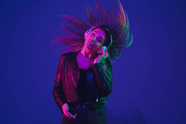 istock Caucasian woman's portrait isolated on blue studio background in neon light 1211589244