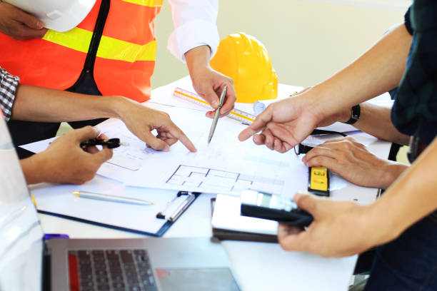 istock Team Engineers are writing solar panel for home construction designs to bring them to prospective customers.concept 1211590000