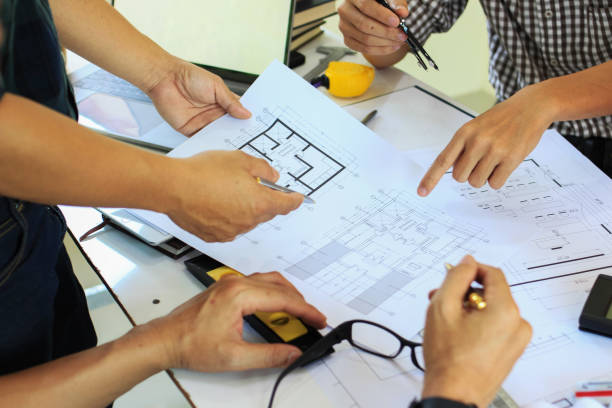 istock Team Engineers are writing solar panel for home construction designs to bring them to prospective customers.concept 1211590013
