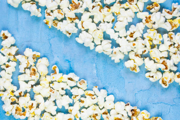 istock Salty butter popcorn laying on the blue background 1211590781