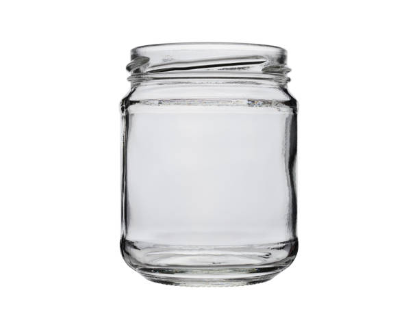 istock Open empty glass food jar, isolated on a white background 1211590998