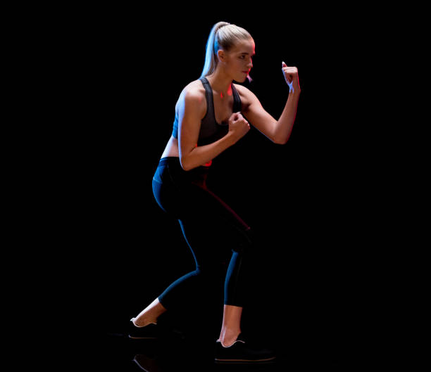 caucasian female in front of black background wearing sports shoe - profile photo flash imagens e fotografias de stock