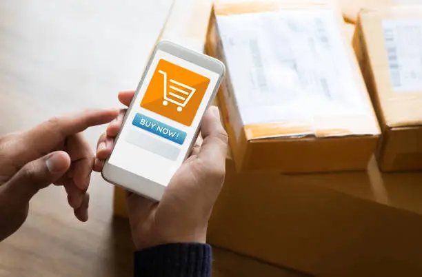 Online shopping concepts with youngman using smartphone on product package box.Ecommerce market.Transportation logistic.Business retail.Seller and buyer