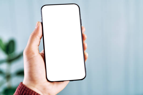 istock Woman holding and touching blank screen template smart phone. Smart phone screen is empty with clipping path. 1211592341