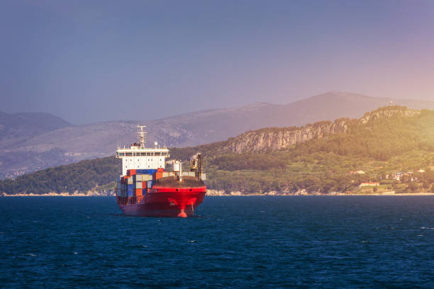 istock Container cargo ship, import export business logistic and transportation of International by container ship in the open sea. Logistics and transportation of International Container Cargo ship. 1211592369