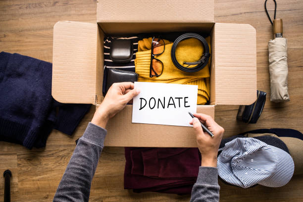 istock Donation concepts with person writing text donate message on accessories in box.giving and sharing with human 1211592586