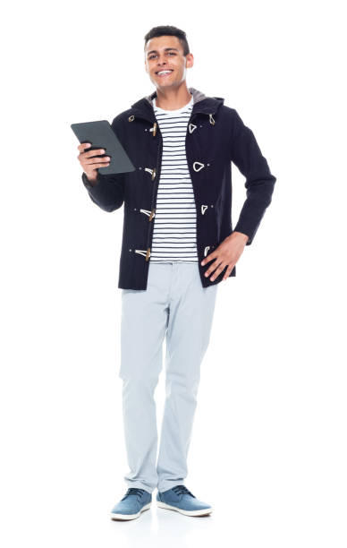 istock African ethnicity male standing in front of white background wearing jacket and using digital tablet 1211593048