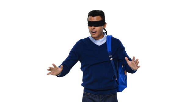 istock Generation z young male standing in front of white background wearing backpack 1211594256