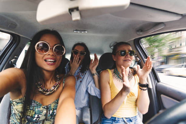 istock Girls in a car 1211595511