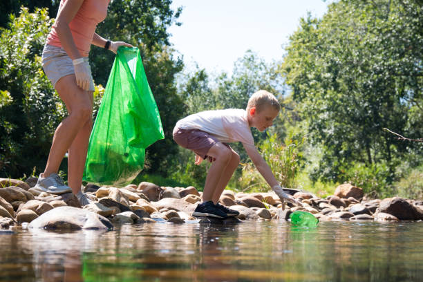 istock Collecting recycling from the river and learning about sustainability 1211595908