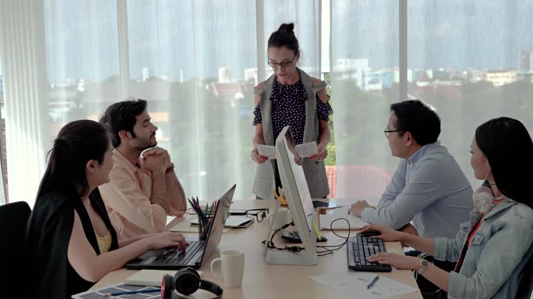 zoom in video shot of The female business team leader is presenting a plan and brainstorming meeting for the business team to succeed.