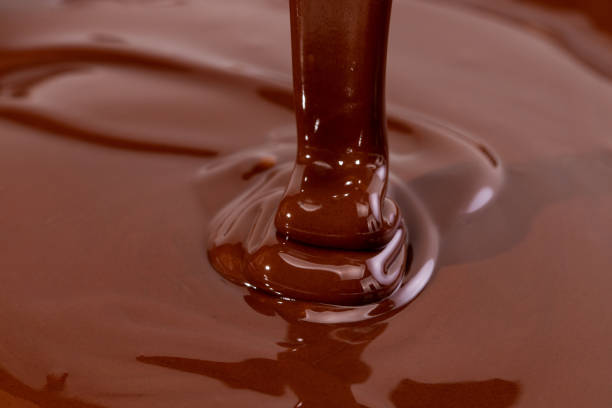 istock Melted chocolate swirl background. Liquid chocolate close-up 1211596260