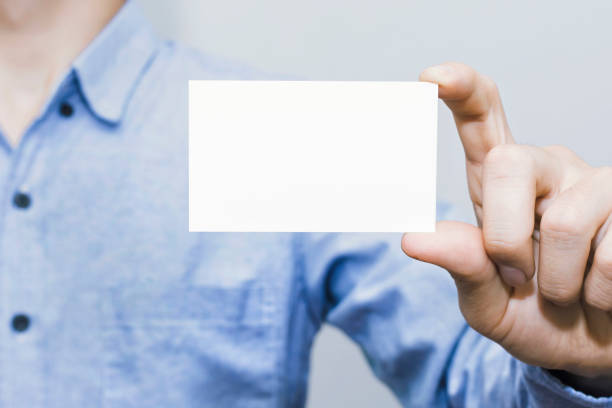 istock Man holding white business card on,mockup template 1211599849