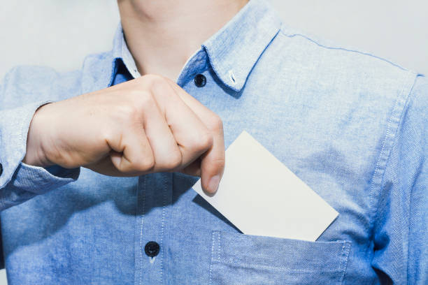 istock Man holding white business card on,mockup template 1211600311