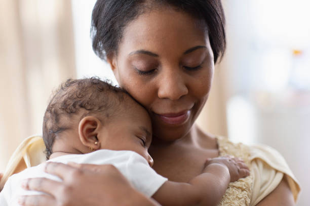 istock Mother holding her sleeping daughter 1211600895