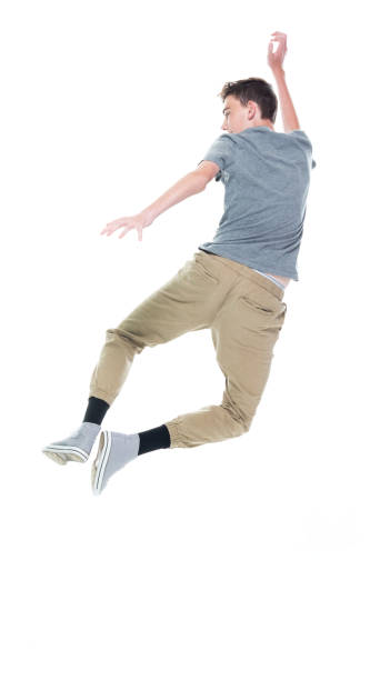 istock Caucasian boys jumping in front of white background 1211601555