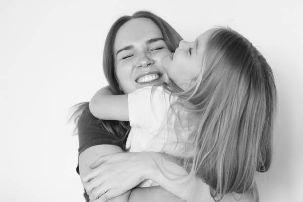 istock mother and daughter hug each. black-white. 1211601757