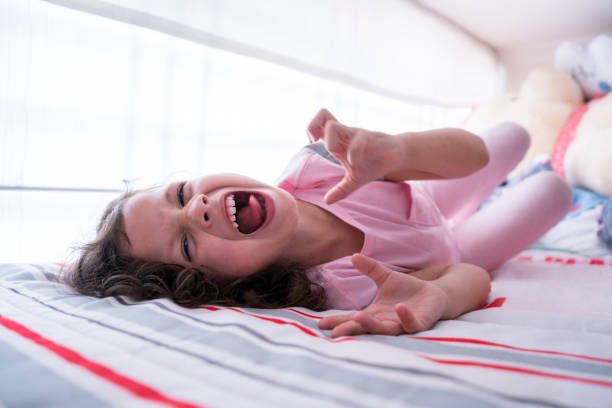 istock Latin girl lying on her camera making funny faces 1211604292