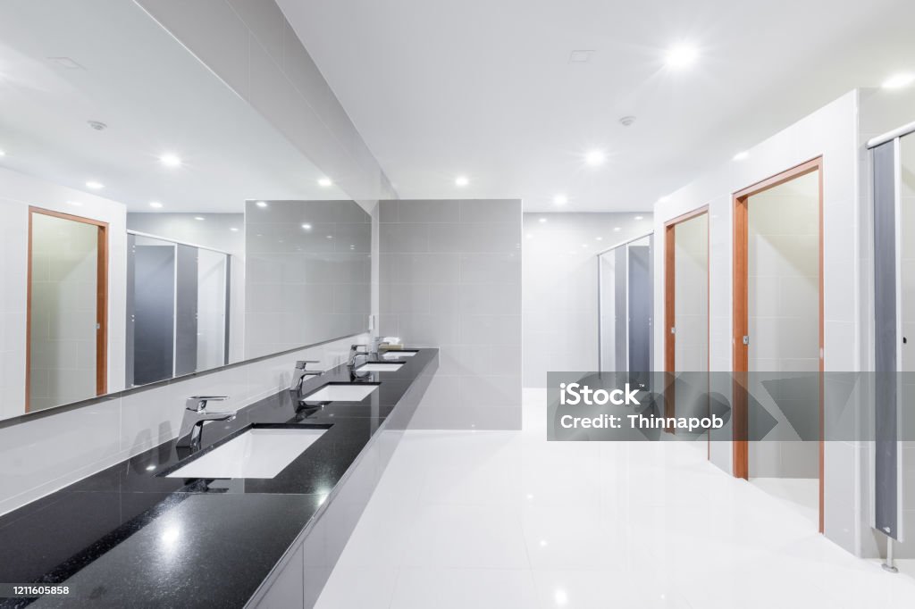 public Interior of bathroom with sink basin faucet lined up Modern design. Public Restroom Stock Photo