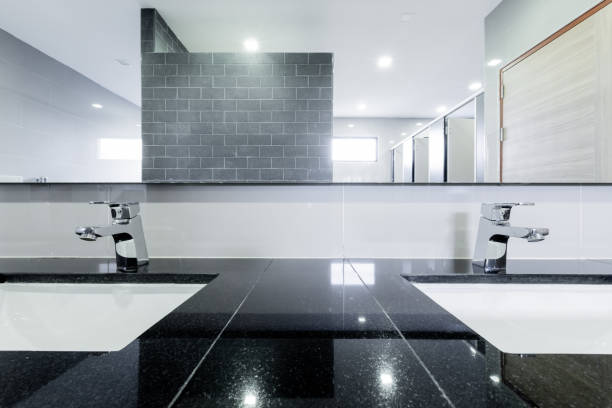 istock public Interior of bathroom with sink basin faucet lined up Modern design. 1211605949