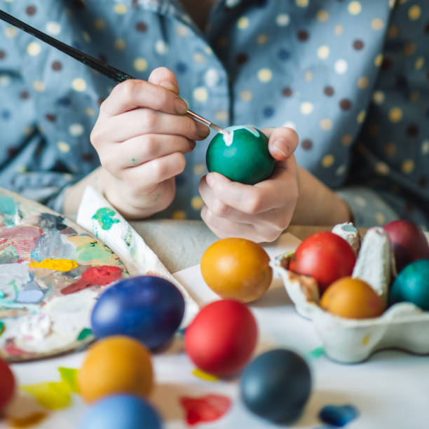 istock Young girl painting on Easter egg 1211606164