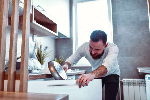 istock Male Sorting Dishes After Washing 1211606205