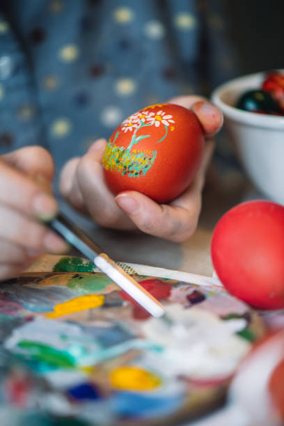 istock Young girl painting on Easter egg 1211606418