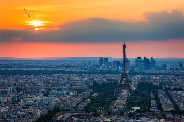 istock View of Paris with Eiffel Tower from Montparnasse building. Eiffel tower view with flying birds from Montparnasse at sunset, view of the Eiffel Tower and La Defense district in Paris, France. 1211606968