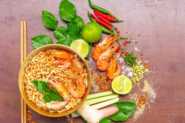 Photo of Instant Noodles Shrimp Tom Yum Flavor,Instant Noodles Shrimp Tom Yum Flavor is the most popular Thai food, served in wooden bowl and place on the table