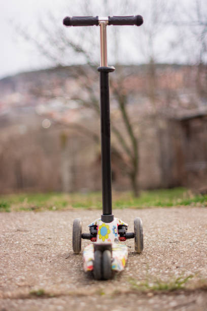istock Toy scooter in yard 1211608138