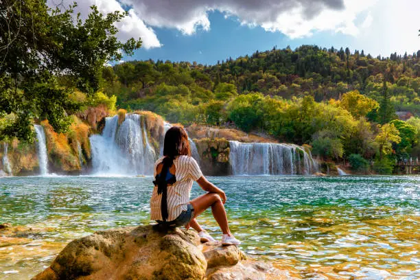 Photo of KRK waterfalls, woman watching waterfall Croatia Krk national park