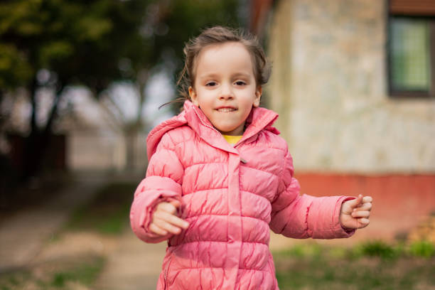 little girl running in the yard