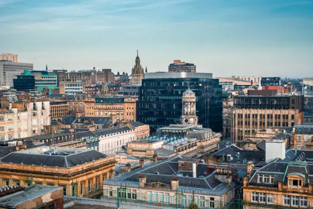 A rooftop view of the mixed architecture of old and new buildings in Glasgow city in late afternoon light, Scotland