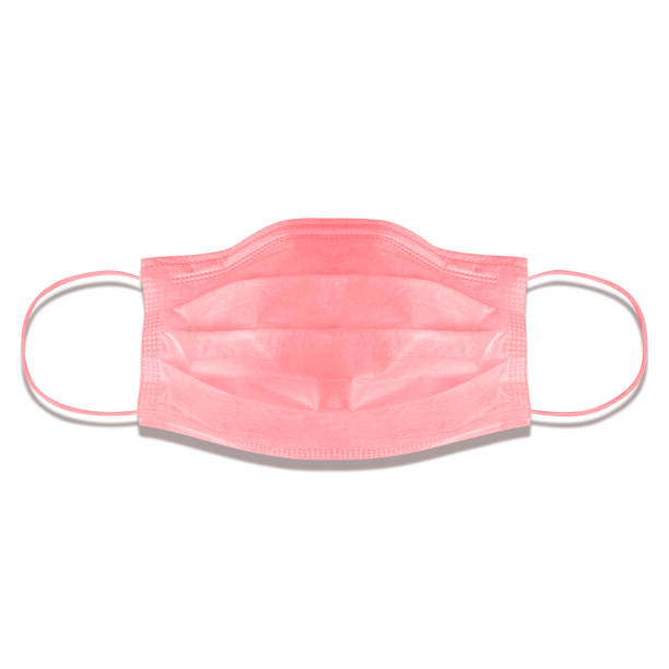 typical 3-ply medical mask isolated on white. hard lighted, harsh shadow. pink surgical ear-loop mask. surgical mask with rubber ear straps to cover the mouth and nose. procedure mask from bacteria. - flu virus cold and flu swine flu epidemic imagens e fotografias de stock