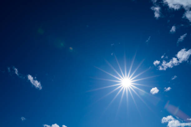 istock Bright blue sky with the sun causing lens flare 1211617552