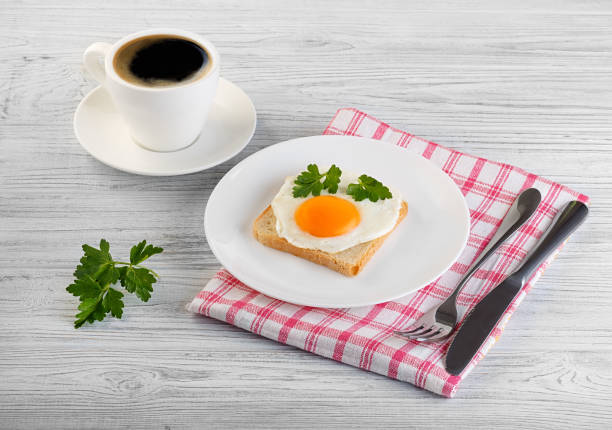 istock coffee fried egg bread parsley sandwich wooden white 1211620356