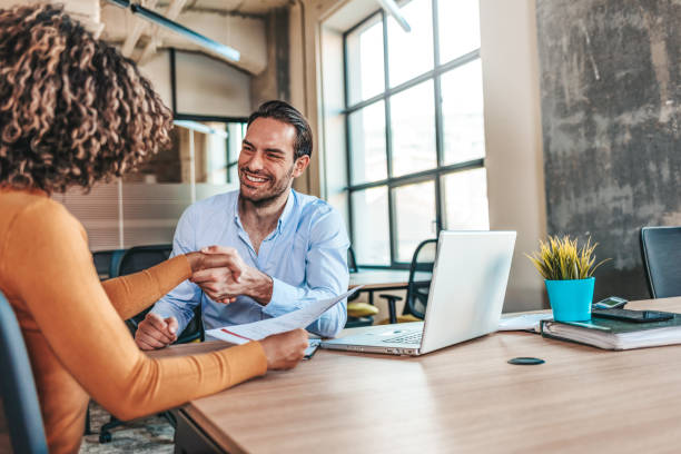 We know no limits Smiling male worker shaking hand of satisfied female African-American colleague, business partners handshaking after successful negotiation on cooperation issues, greeting with achieved goal. Partnership concept good cv stock pictures, royalty-free photos & images